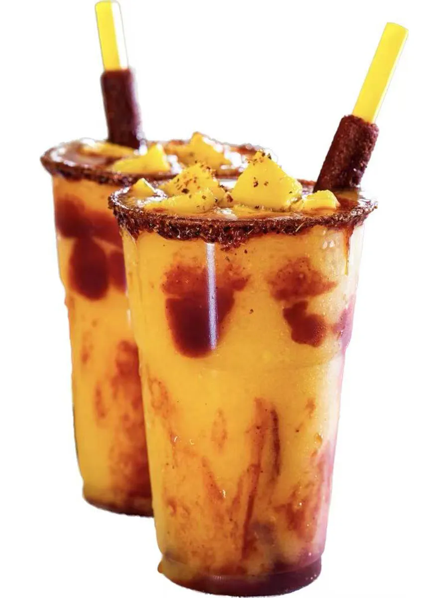 Two mango slush drinks with chamoy rim and tamarind straw at Kungfu Rice, a Chinese Fast Food Restaurant in Savannah