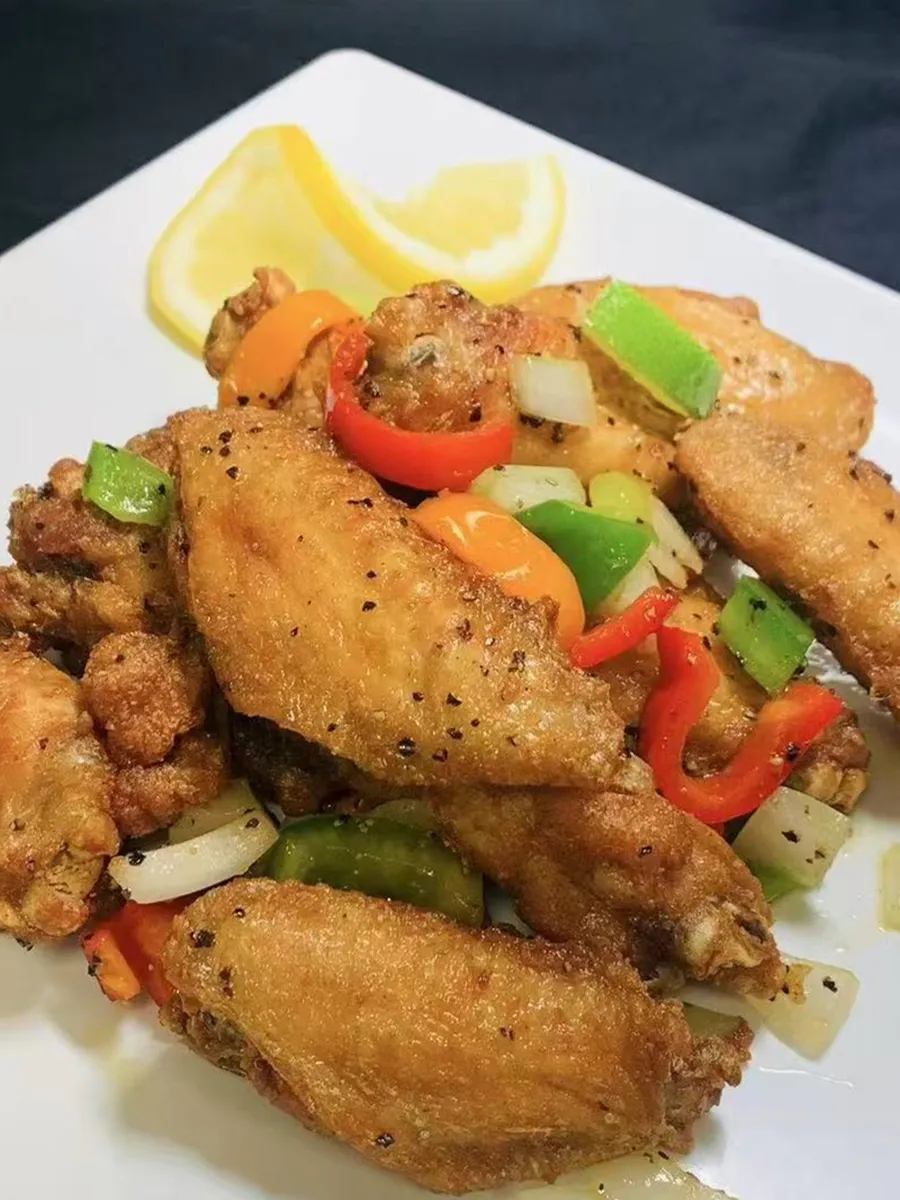 Stir-fried fried chicken wings with bell peppers and lemon at Kungfu Rice, a Chinese Fast Food Restaurant in Savannah