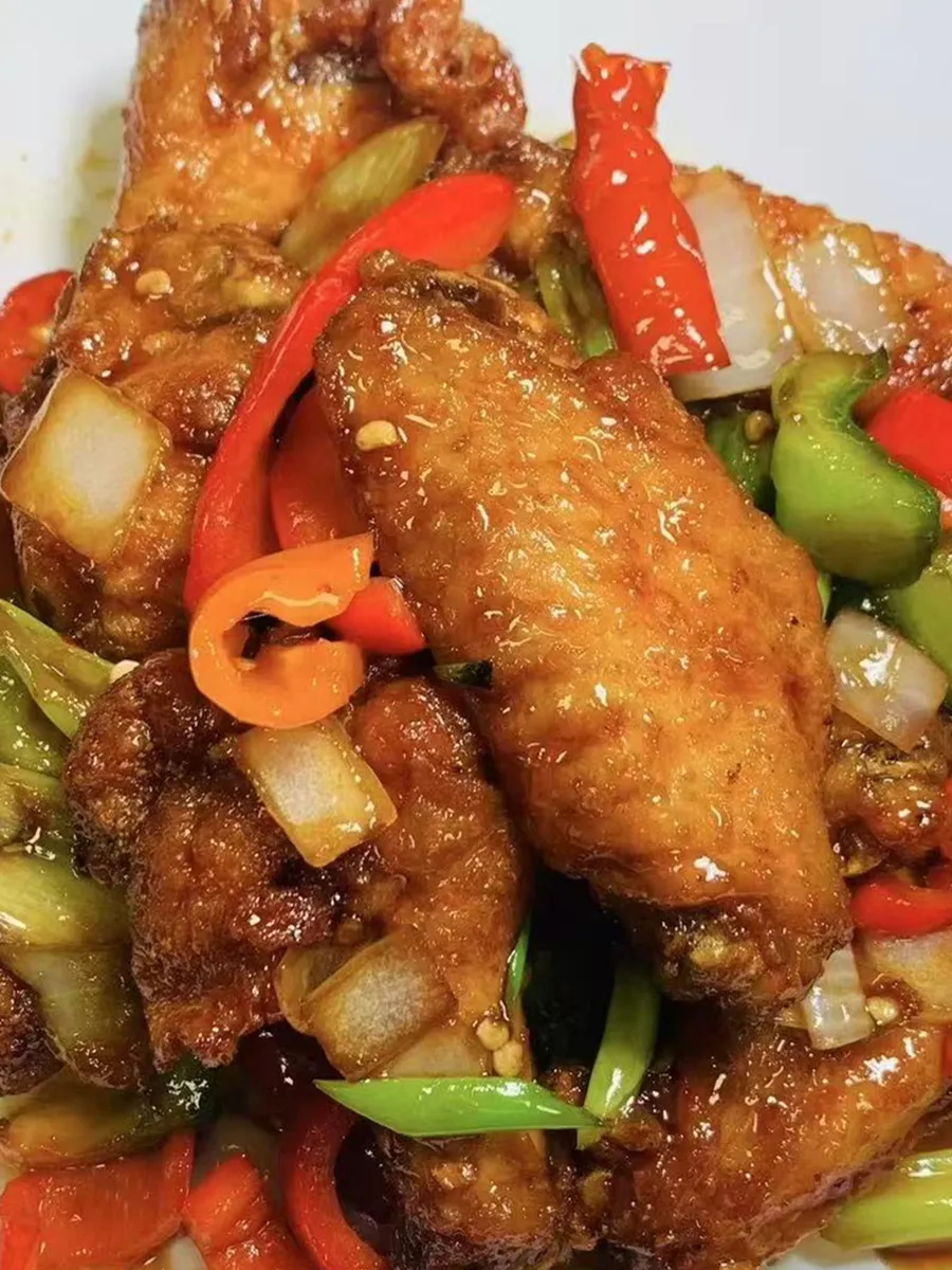 Braised chicken wings with bell peppers in savory sauce at Kungfu Rice, a Chinese Fast Food Restaurant in Savannah