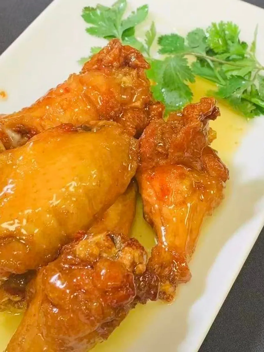 Honey glazed fried chicken wings with cilantro garnish at Kungfu Rice, a Chinese Fast Food Restaurant in Savannah